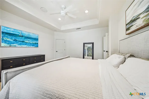 a spacious bedroom with a bed and a window