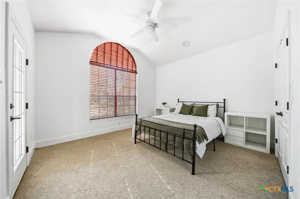 front view of house with a yard and potted plants