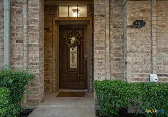 a view of a hallway with a flower pot