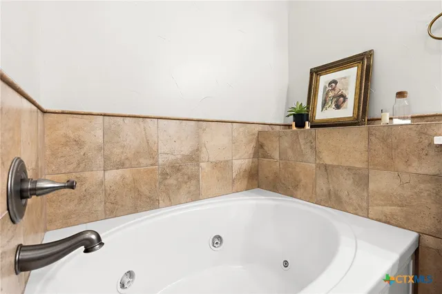 a white toilet sitting next to a white wall