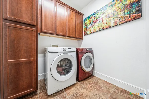 a view of a swimming pool with some potted plants and large trees