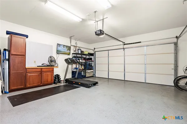 an aerial view of a city with lots of residential buildings ocean and mountain view in back