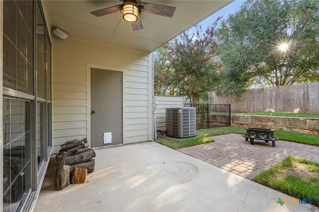 front view of house with a yard and potted plants