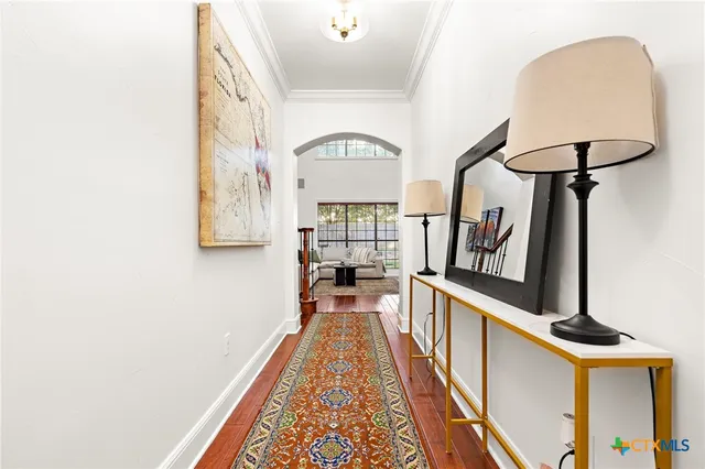 a view of a hallway with wooden floor and staircase