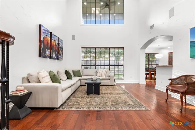 a living room with furniture and wooden floor