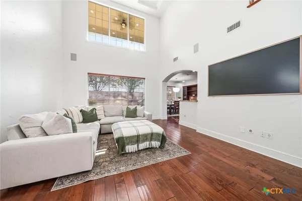 a living room with furniture and a wooden floor