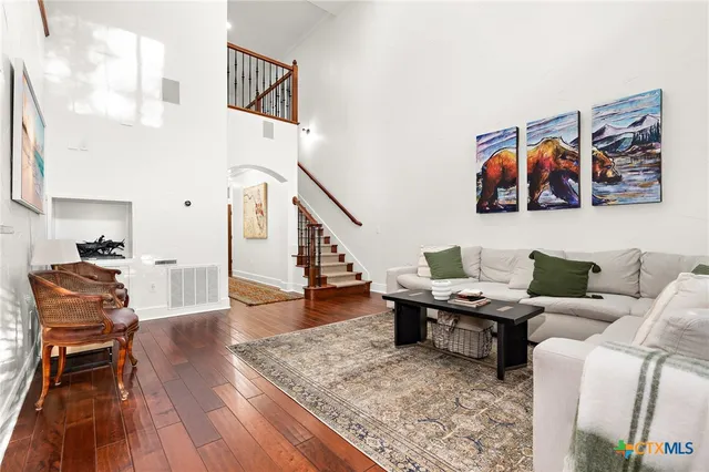 a living room with furniture and wooden floor