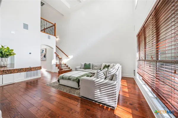 a kitchen with stainless steel appliances granite countertop a refrigerator a stove and a wooden floors