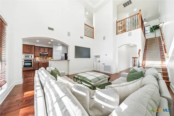 a dining room with furniture and wooden floor