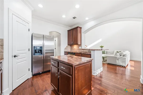 a spacious bedroom with a large bed and a chandelier