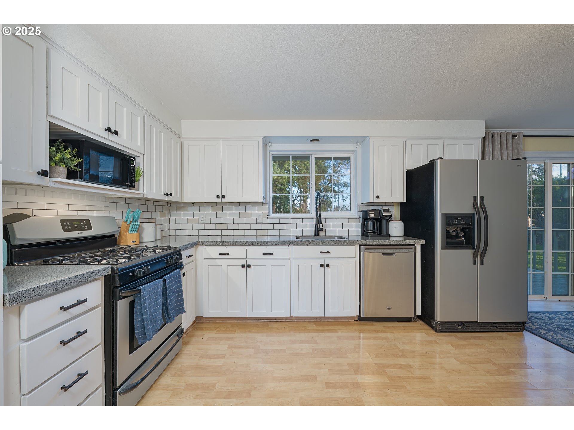 5970 Southwest 174th Avenue Beaverton, OR 97007 - Photo 6 of 36 a kitchen with stainless steel appliances granite countertop a stove a sink dishwasher a refrigerator and a microwave