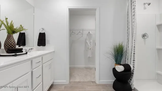 a bathroom with a double vanity sink and a mirror