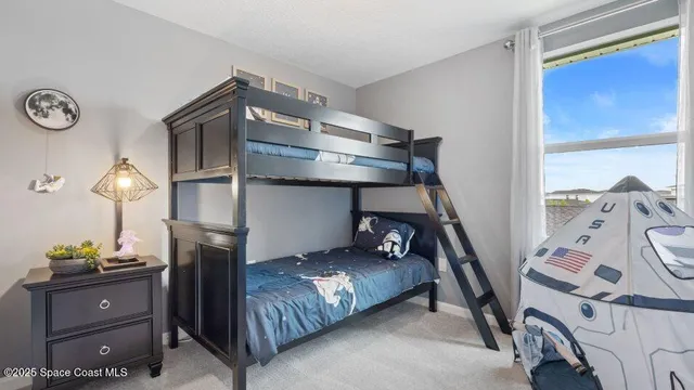 a bedroom with a bed and a mirror