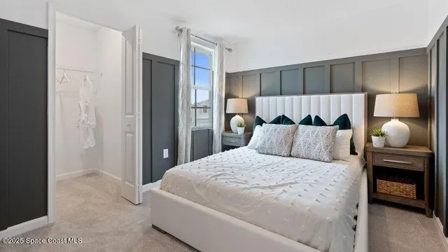 a bedroom with a bed and a lamp