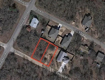 an aerial view of a house with a yard and trees