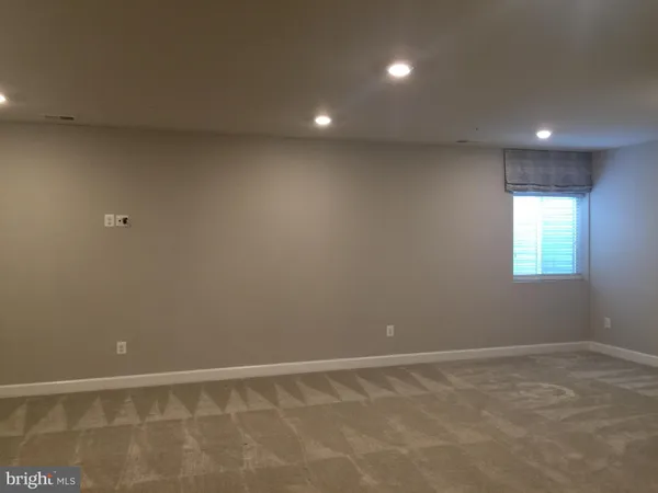 a view of an empty room with window and pillar in it