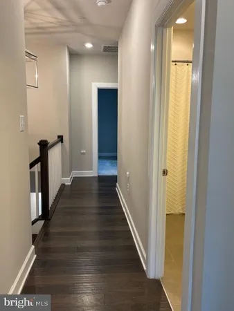 a bathroom with a granite countertop sink toilet and mirror