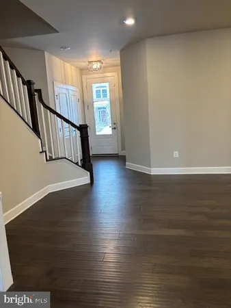 a view of an entryway with wooden floor