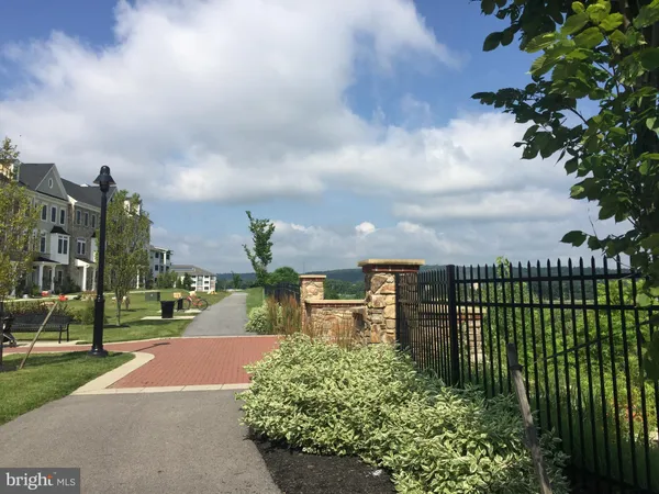 a kitchen with stainless steel appliances kitchen island granite countertop a stove a sink and a microwave