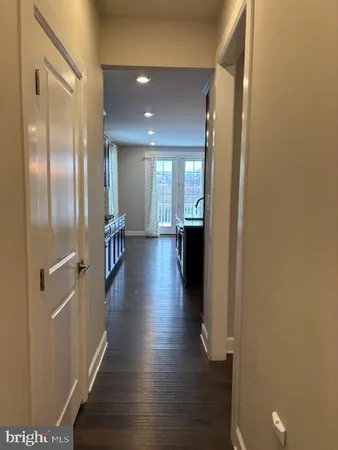 a kitchen with stainless steel appliances a kitchen island hardwood floor sink stove and wooden floor