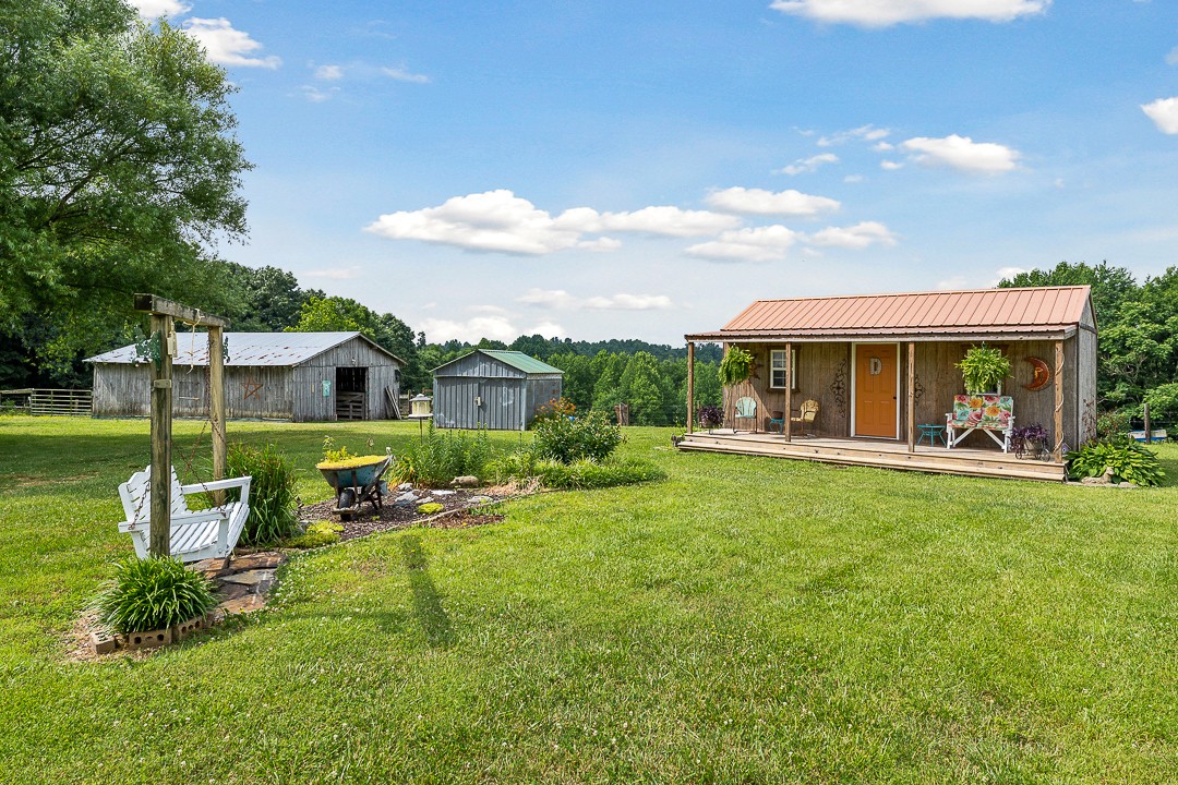 795 Owens Road Lafayette, TN 37083 - Photo 17 of 50 a view of house with a big yard and potted plants
