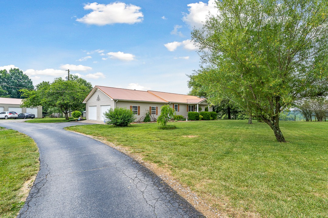 795 Owens Road Lafayette, TN 37083 - Photo 27 of 50 a view of a house with a big yard plants and large trees