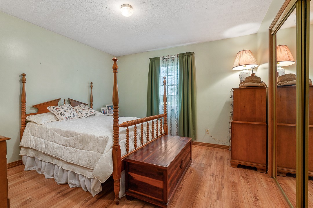 795 Owens Road Lafayette, TN 37083 - Photo 46 of 50 a bedroom with a bed and wooden floor
