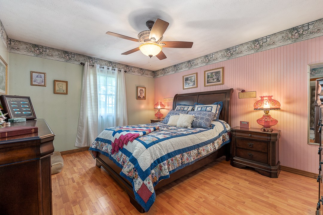 795 Owens Road Lafayette, TN 37083 - Photo 49 of 50 a bedroom with a bed and wooden floor