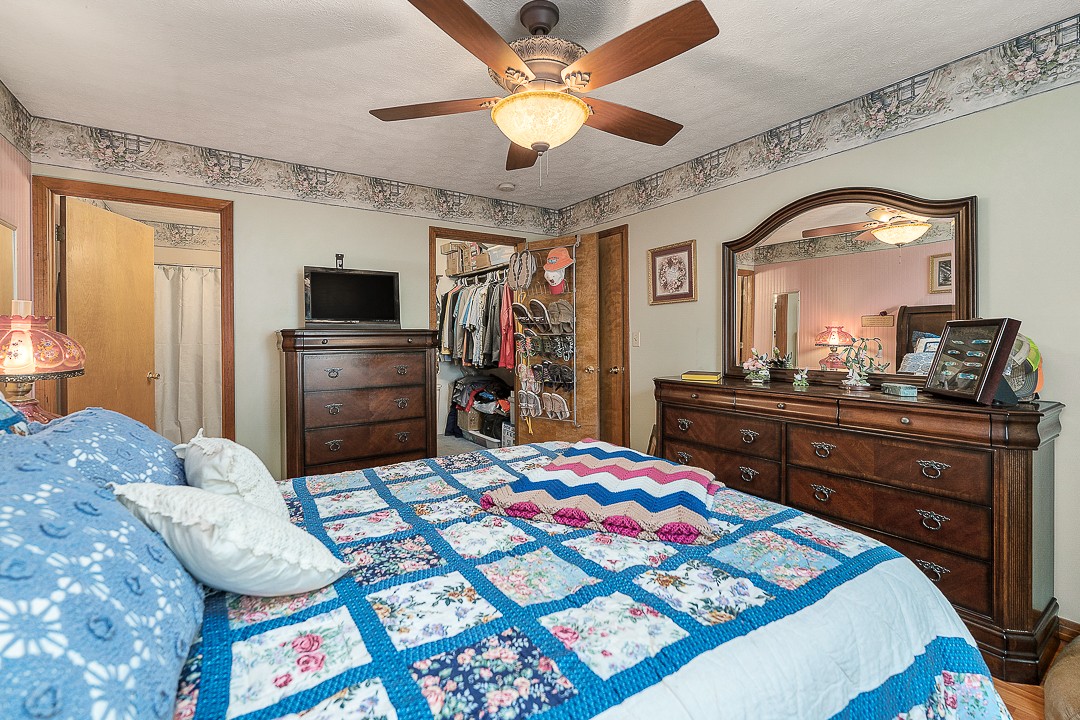 795 Owens Road Lafayette, TN 37083 - Photo 50 of 50 a bedroom with a bed and a chandelier