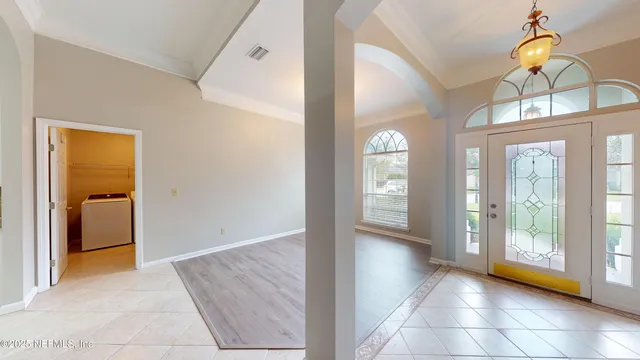 a view of a hallway view with wooden floor and a living room