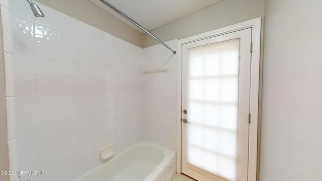 a spacious bathroom with a bathtub and a shower