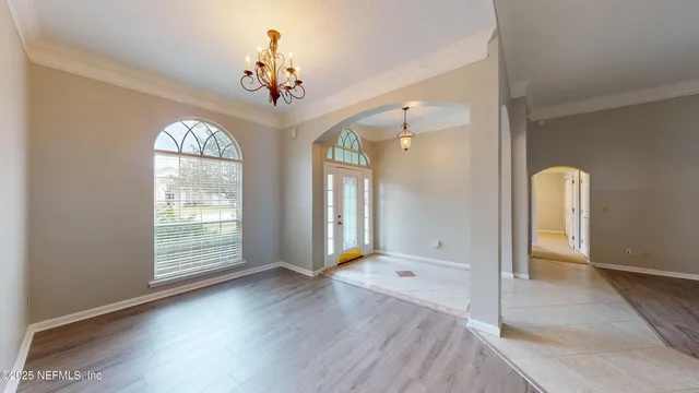 a view of a room with wooden floor and window