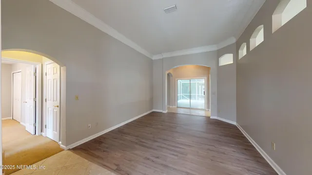 a view of an empty room and a window