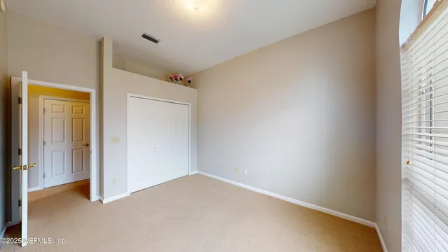 a view of a big room with wooden floor and windows