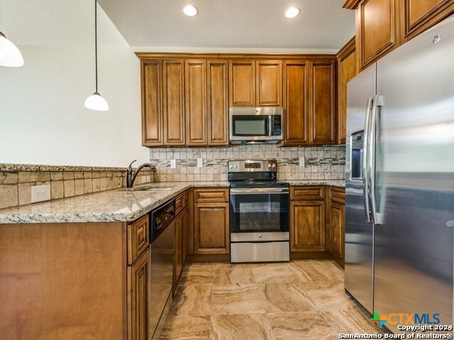 2544 Puter Creek Road, Unit A Spring Branch, TX 78070 - Photo 1 of 17 a kitchen with stainless steel appliances granite countertop a sink stove microwave and refrigerator