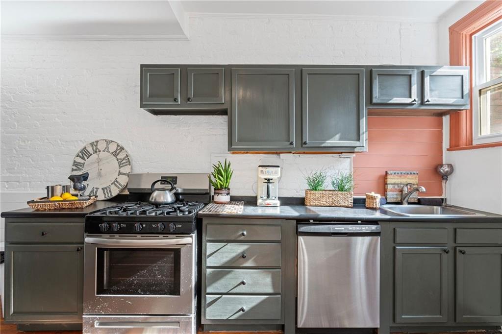 420 Fisk Street Pittsburgh, PA 15224 - Photo 12 of 30 a kitchen with stainless steel appliances granite countertop a stove a sink and a microwave