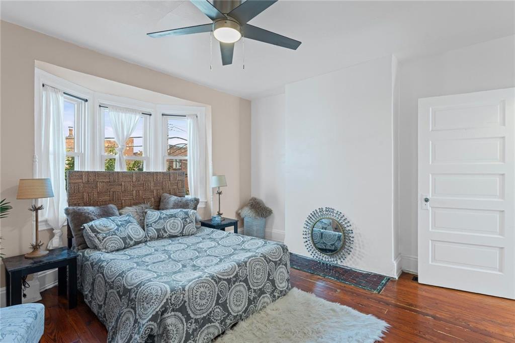 420 Fisk Street Pittsburgh, PA 15224 - Photo 16 of 30 a bedroom with a bed and a chandelier