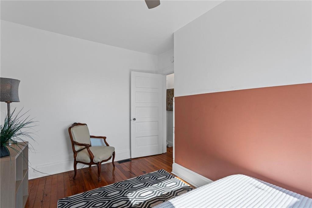 420 Fisk Street Pittsburgh, PA 15224 - Photo 20 of 30 a bedroom with a bed and wooden floor