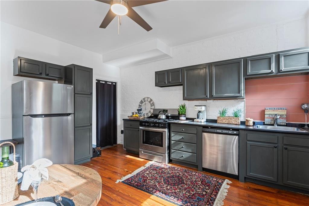 420 Fisk Street Pittsburgh, PA 15224 - Photo 10 of 30 a kitchen with stainless steel appliances granite countertop a refrigerator a sink a stove a microwave and island