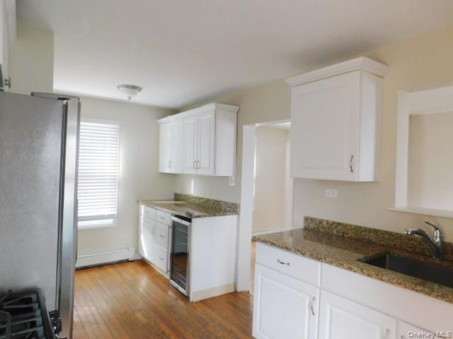10 South Walnut Street Beacon, NY 12508 - Photo 5 of 18 a kitchen with granite countertop white cabinets and white appliances