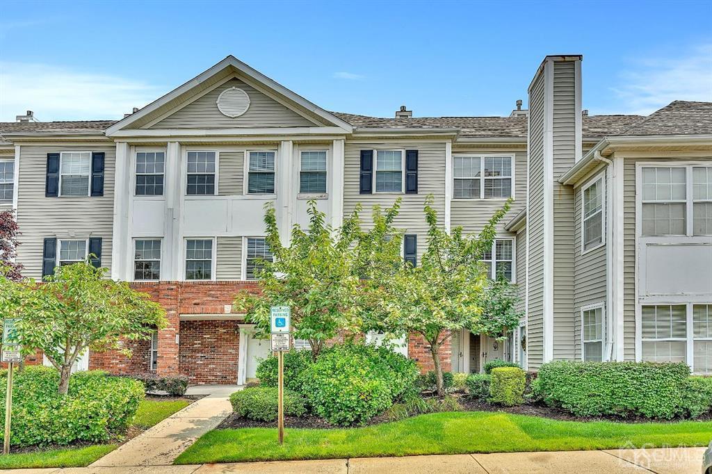 front view of a brick house with a yard