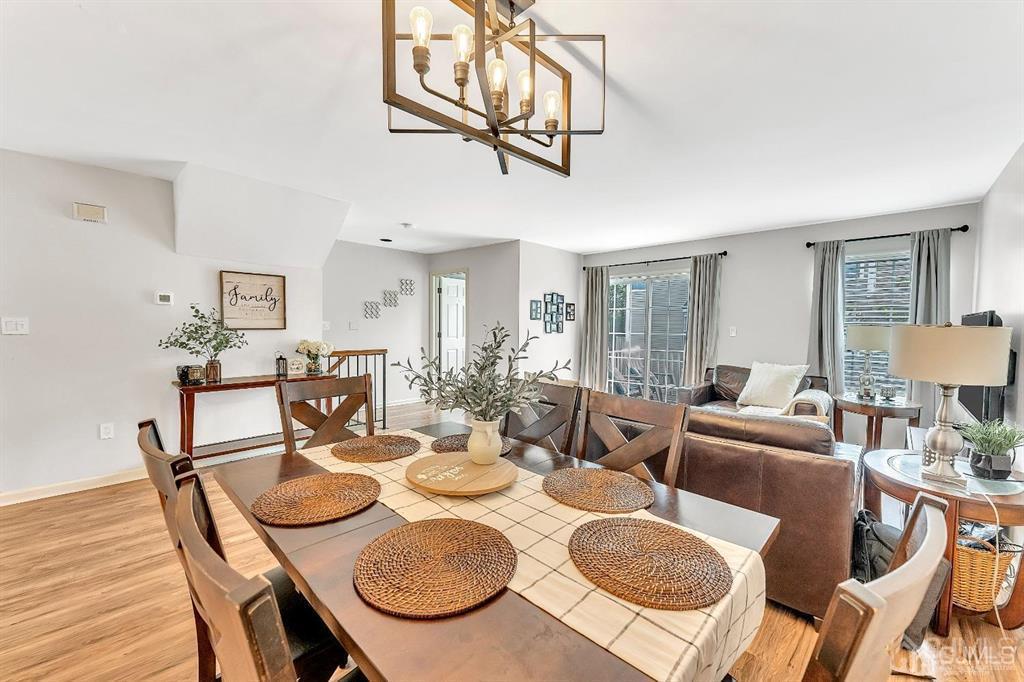 2510 Ridgeview Court Sayreville, NJ 08859 - Photo 13 of 28 a view of a dining room and livingroom with furniture wooden floor a chandelier