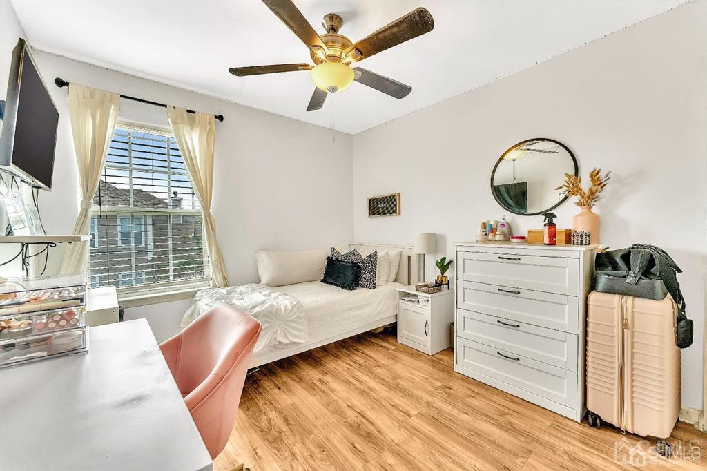 2510 Ridgeview Court Sayreville, NJ 08859 - Photo 20 of 28 a bedroom with a bed and a flat screen tv