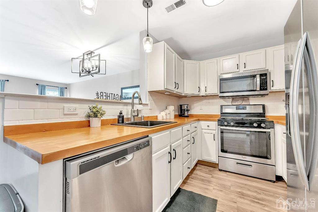 2510 Ridgeview Court Sayreville, NJ 08859 - Photo 8 of 28 a kitchen with stainless steel appliances granite countertop a sink and a stove