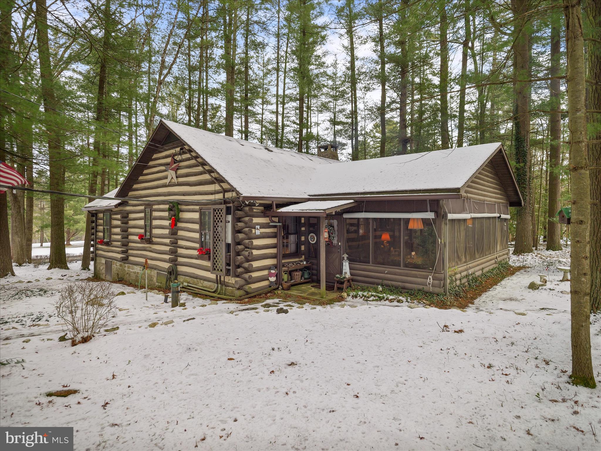 a view of a house with a yard covered in snow