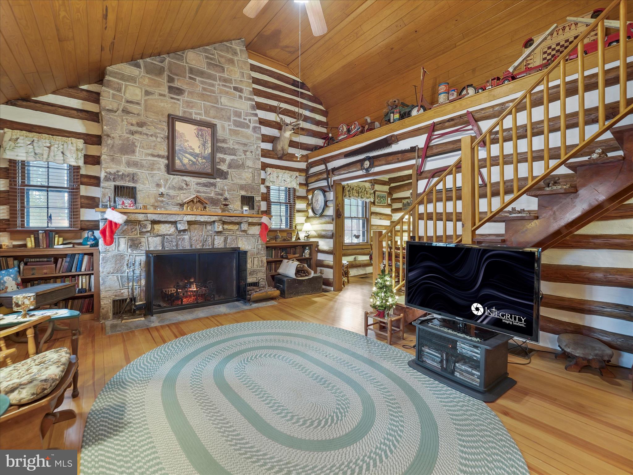 10086 Golf Course Road Fayetteville, PA 17222 - Photo 13 of 33 a living room with furniture a fireplace and a flat screen tv