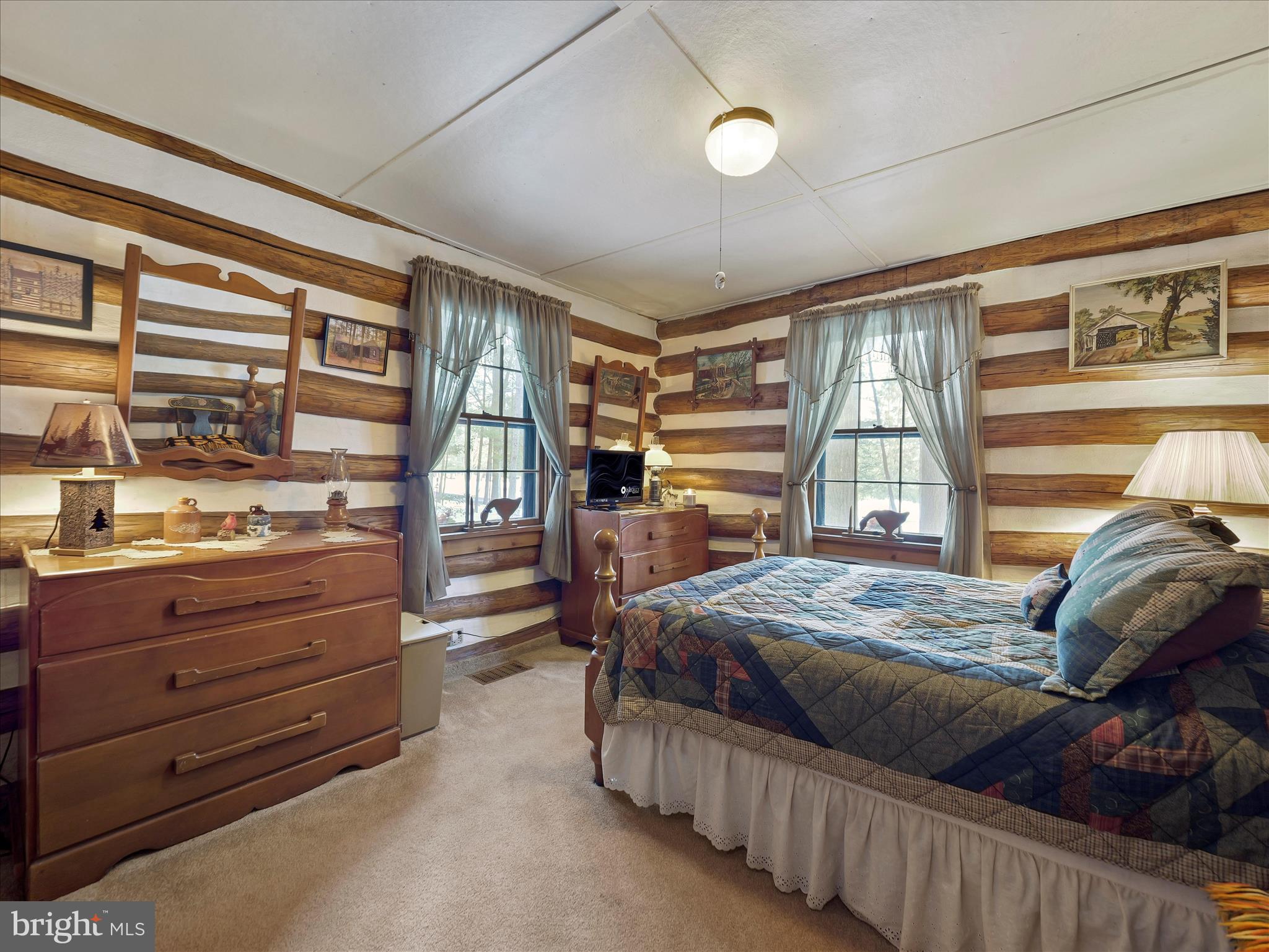 10086 Golf Course Road Fayetteville, PA 17222 - Photo 26 of 33 a bedroom with a bed and large windows