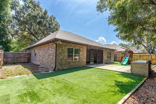 a view of a house with a yard and sitting area