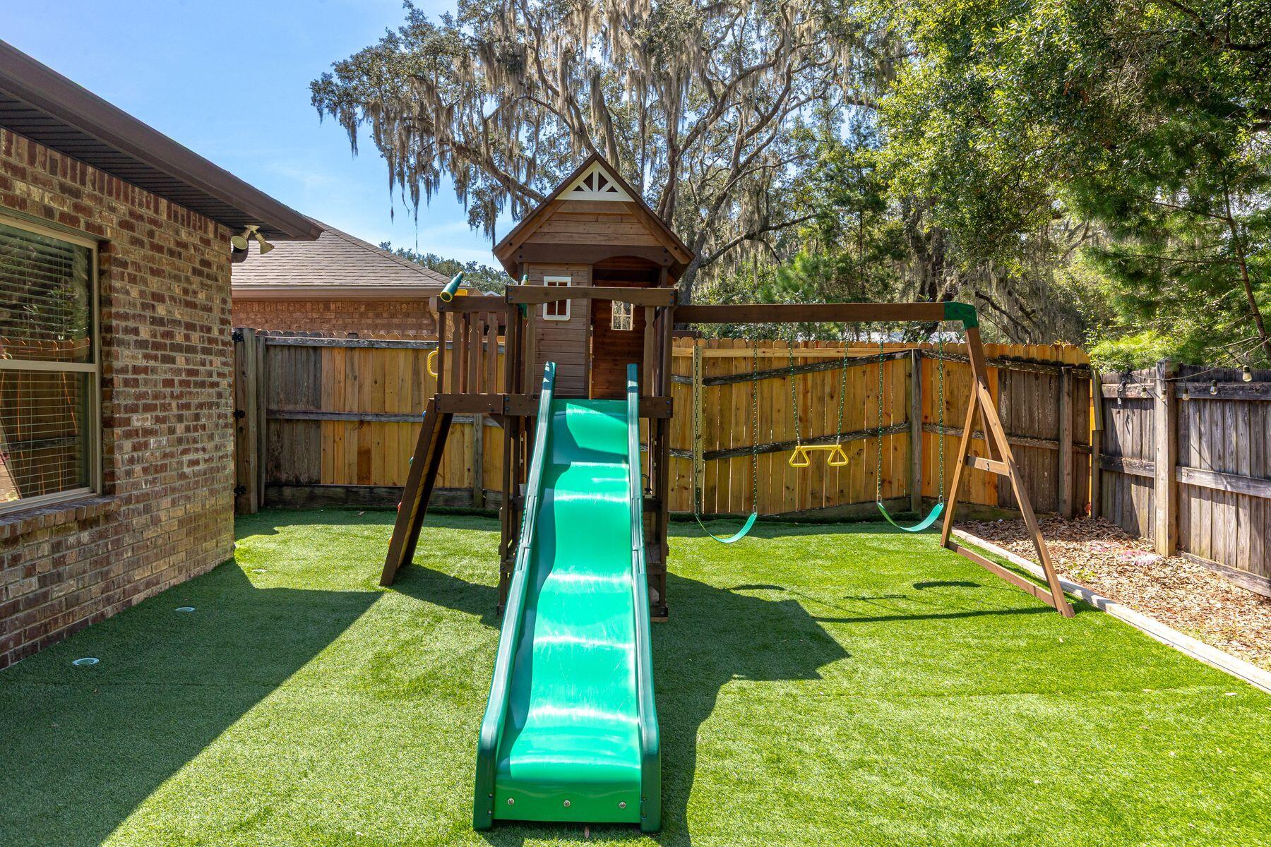 20 Big Oak Lane Santa Rosa Beach, FL 32459 - Photo 14 of 31 a view of a backyard with a slide and a child swing