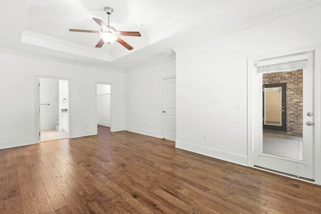 a view of an empty room with wooden floor